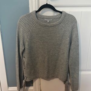 Women’s grey sweater with ties up the side